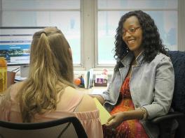 A Career Coach offers resume guidance to a student.
